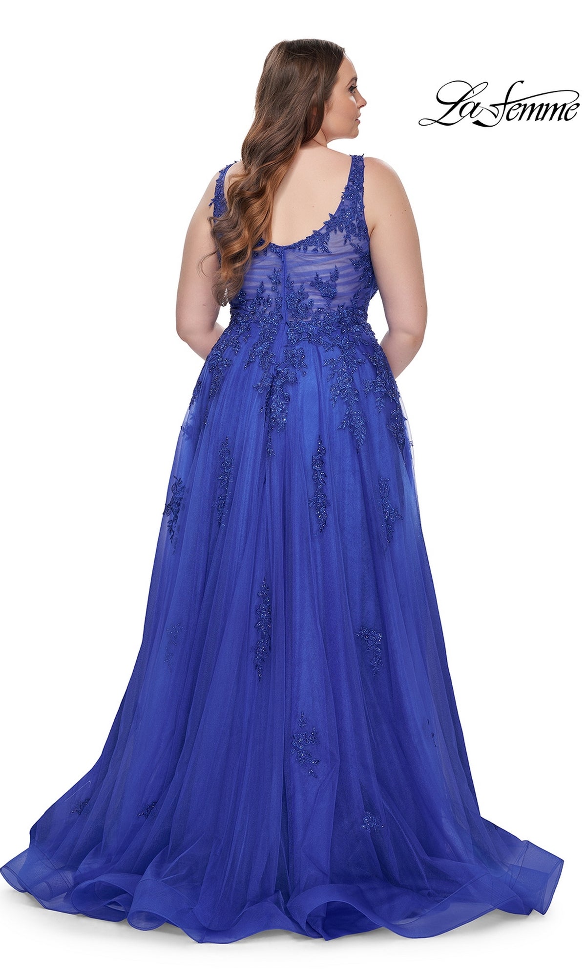 Shown from the back, the La Femme Long Prom Dress 31383 is a royal blue plus-size gown with sleeveless embroidered lace, a sheer beaded bodice, and a flowing floor-length skirt.